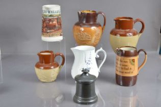 A collection of six various jugs including a Doulton Lambeth harvest jug,