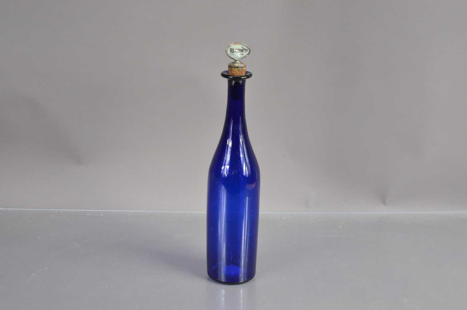 A 'Bristol Blue' glass bottle-shape decanter with silver plated 'Brandy' label stopper,