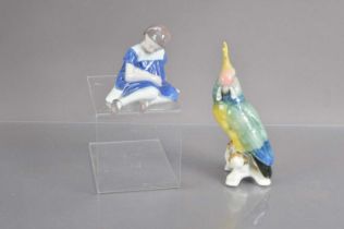 A vintage Karl Ens model of a parrot and a Bing & Grondahl figure of a girl with a doll,