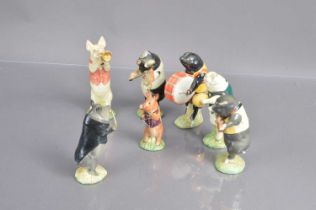 A set of seven Bewsick 'Pig Band' figurines,