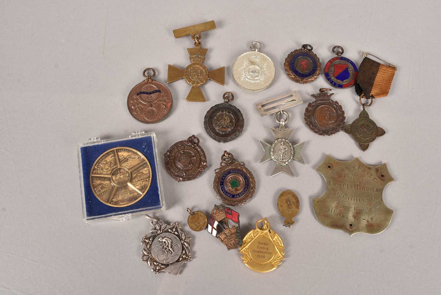 A collection of cycling and other medallions,