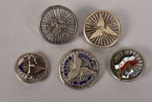 A group of five white metal cycling badges,