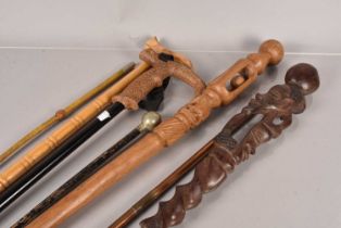 Two carved wooden Tribal Staffs,