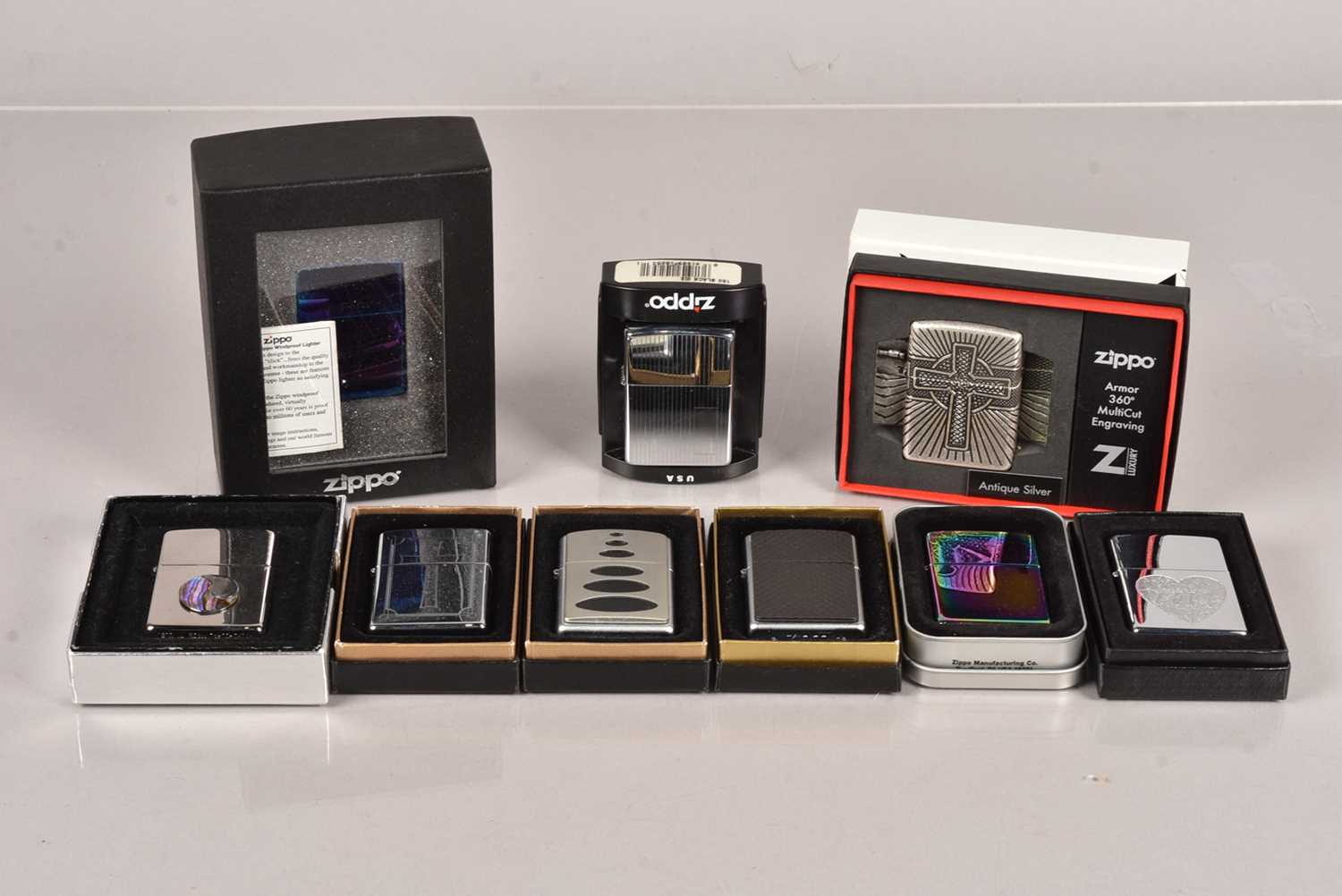 A collection of various Zippo Lighters,