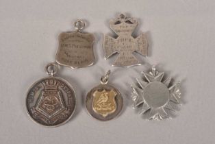 A collection of silver military medallions,