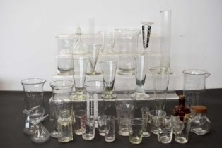 A collection of British and Overseas glass measures,