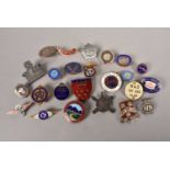 A collection of cycling and other badges,