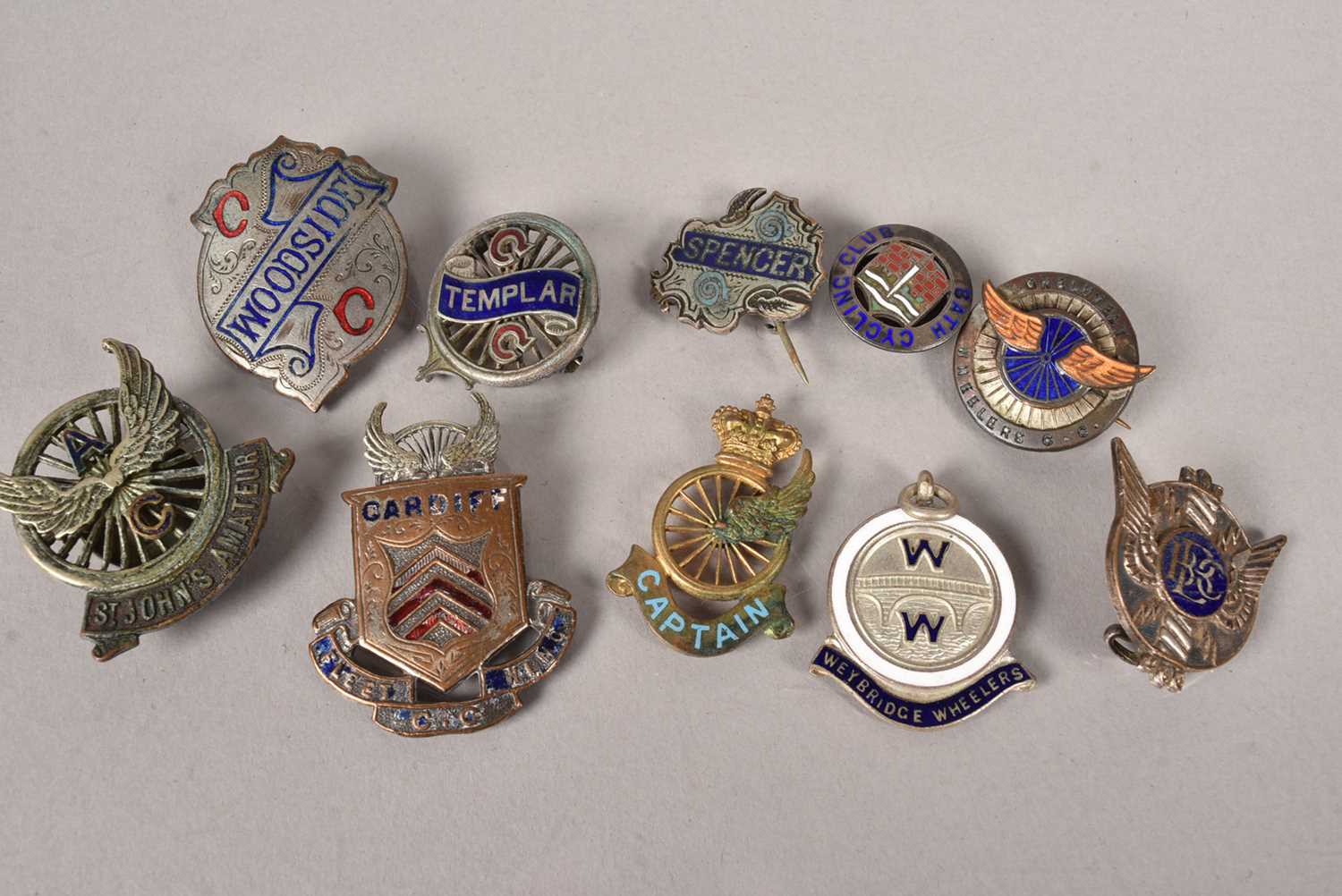 An assortment of Cycling medals and buttons,