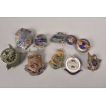 An assortment of Cycling medals and buttons,