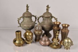 A pair of Middle Eastern metal lidded urns,