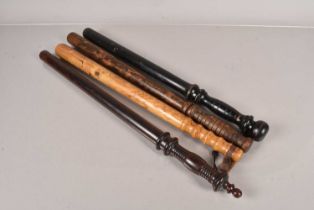 A group of four long wooden truncheons/bludgeons,