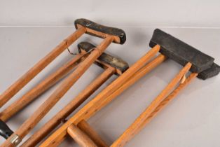 Two pairs of Vintage wooden medical crutches,