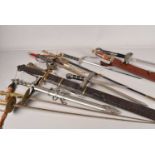 A collection of decorative wall hanger swords and weaponry,