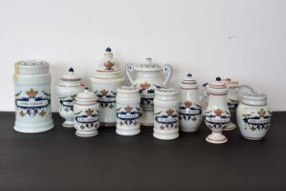 A collection of modern Delft Pharmaceutical lidded containers,