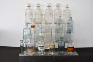 A group of five glass Chemist bottles,