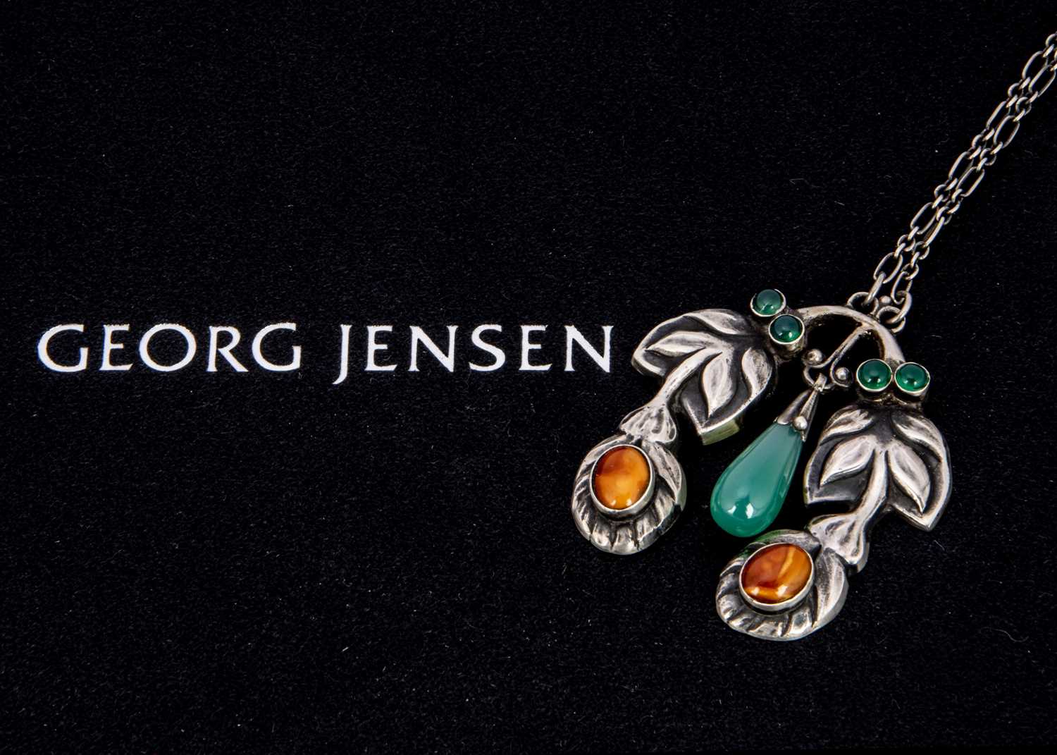 An early 20th century silver Georg Jensen chrysoprase and amber pendant no. 28,