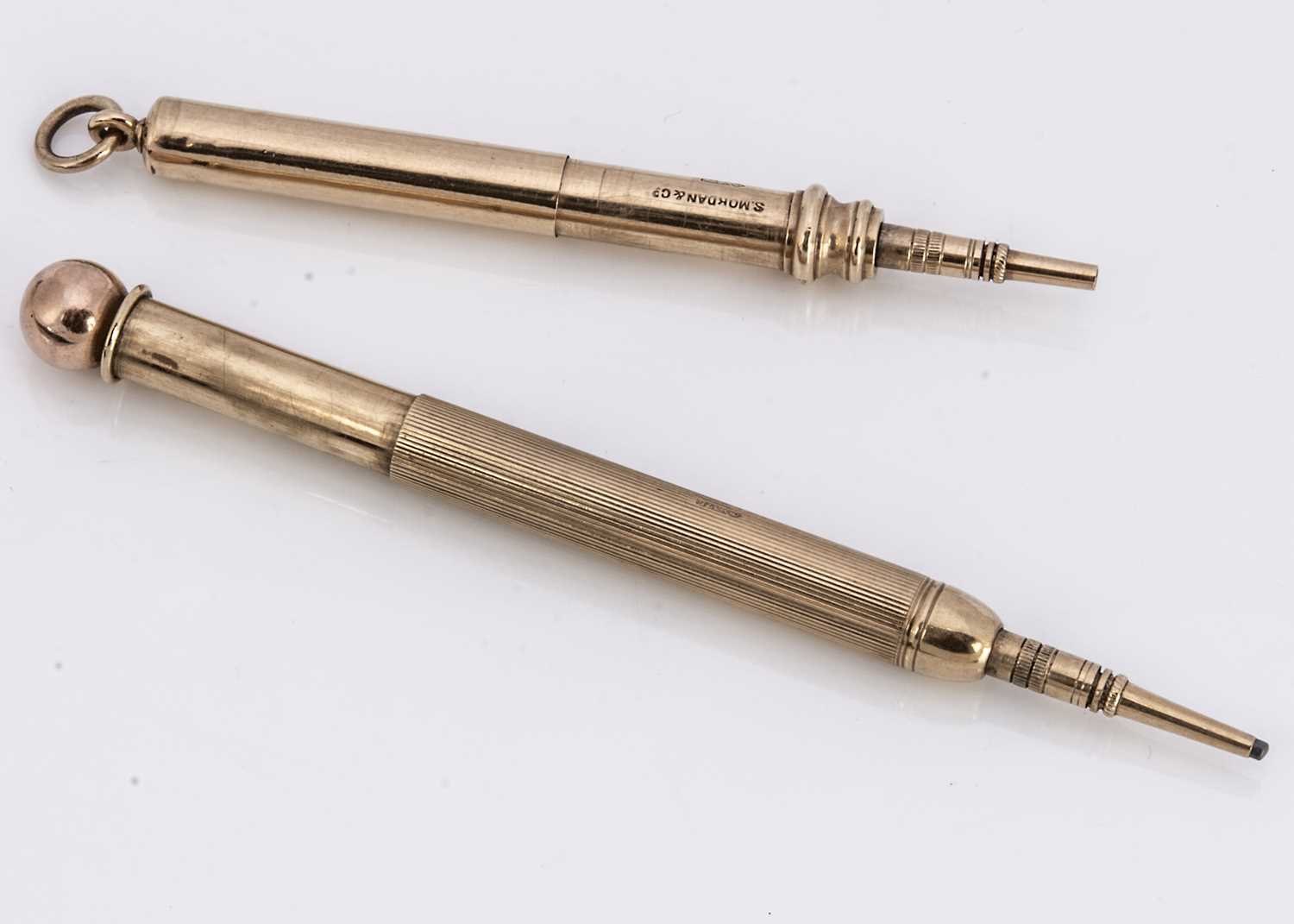 Two 9ct gold telescopic retractable pencils,