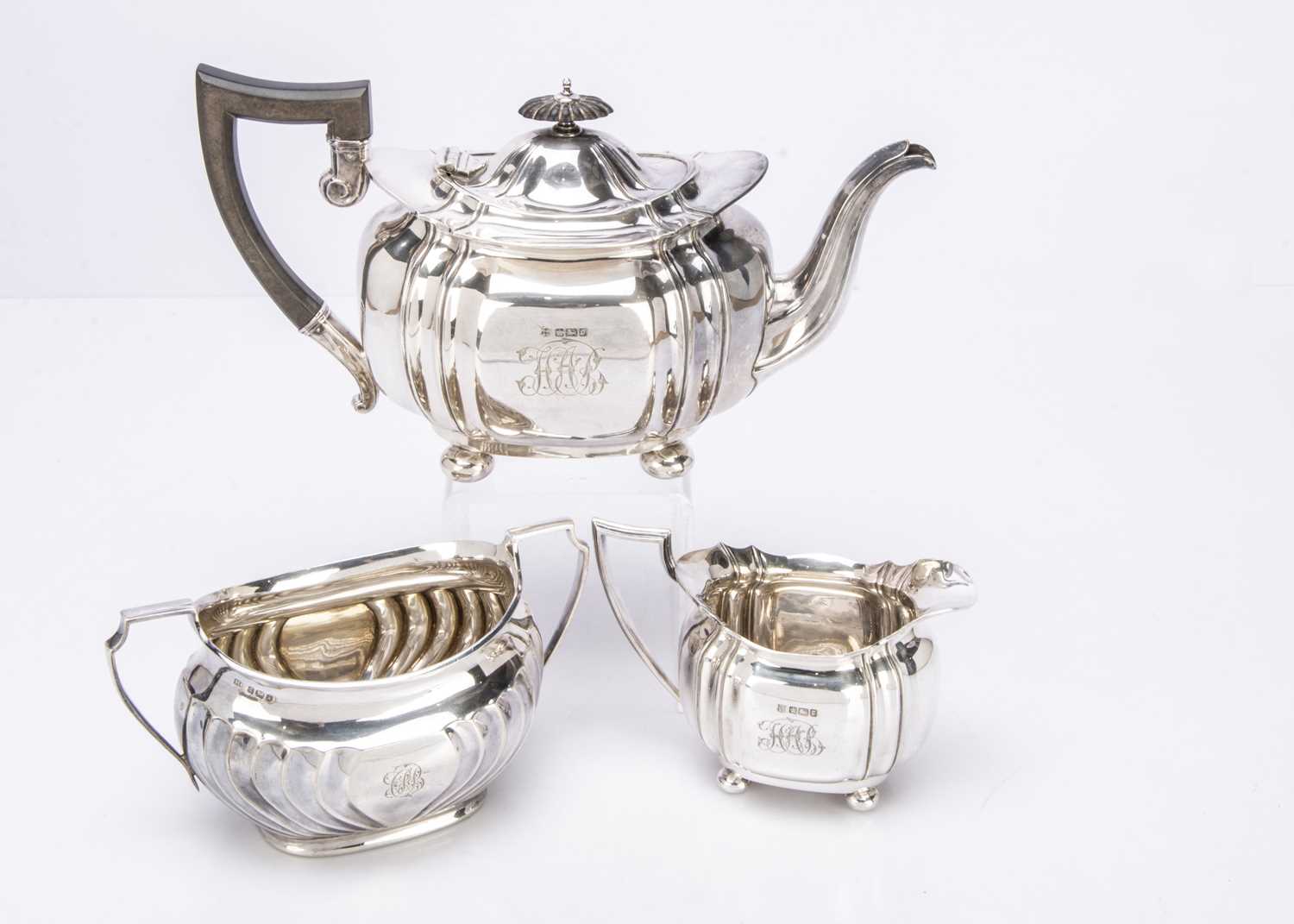 A harlequin Edwardian silver three piece teaset,