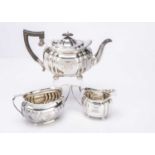 A harlequin Edwardian silver three piece teaset,