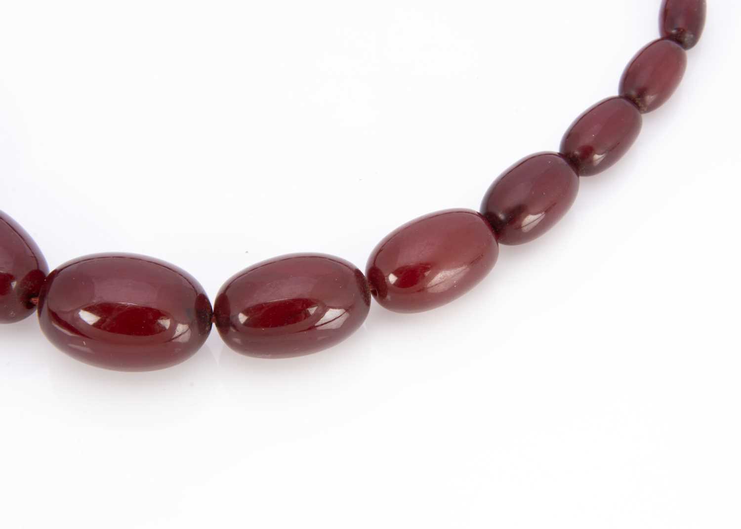 A 'cherry amber' string of graduated beads, - Image 2 of 2