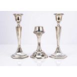 A pair of Art Deco period silver filled candlesticks and another