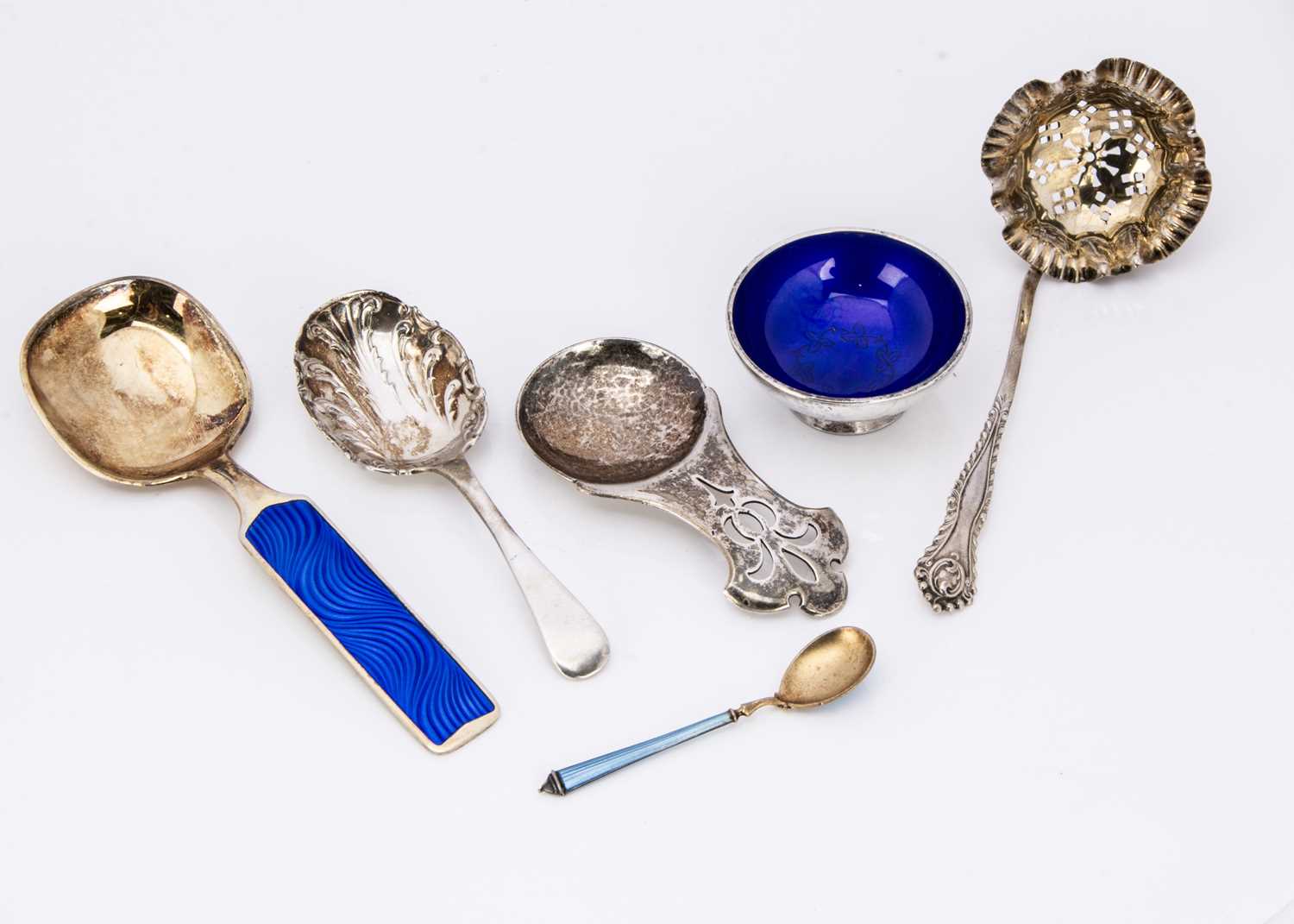 Five collectable spoons and a salt,