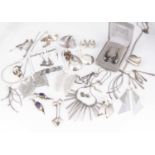 A collection of silver, white metal and plated earrings and jewels,