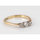 An 18ct gold and platinum diamond three stone dress ring,