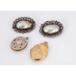 A pair of 19th century mother of pearl and base metal oval brooches,