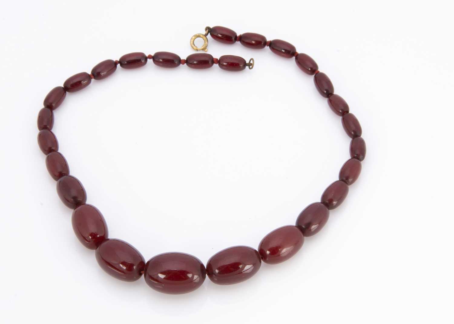 A 'cherry amber' string of graduated beads,