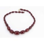 A 'cherry amber' string of graduated beads,