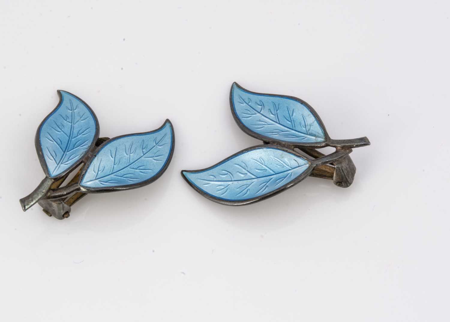 A pair of David Andersen silver and enamel leaf ear clips,