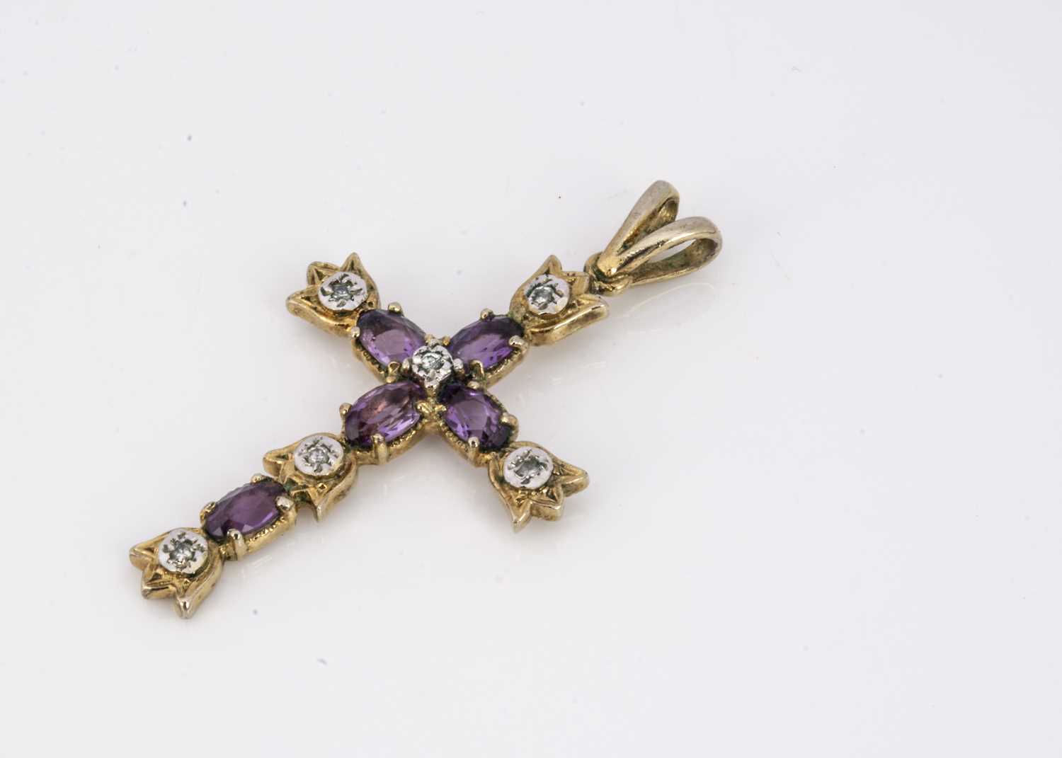 A silver gilt amethyst and diamond cross pendant,