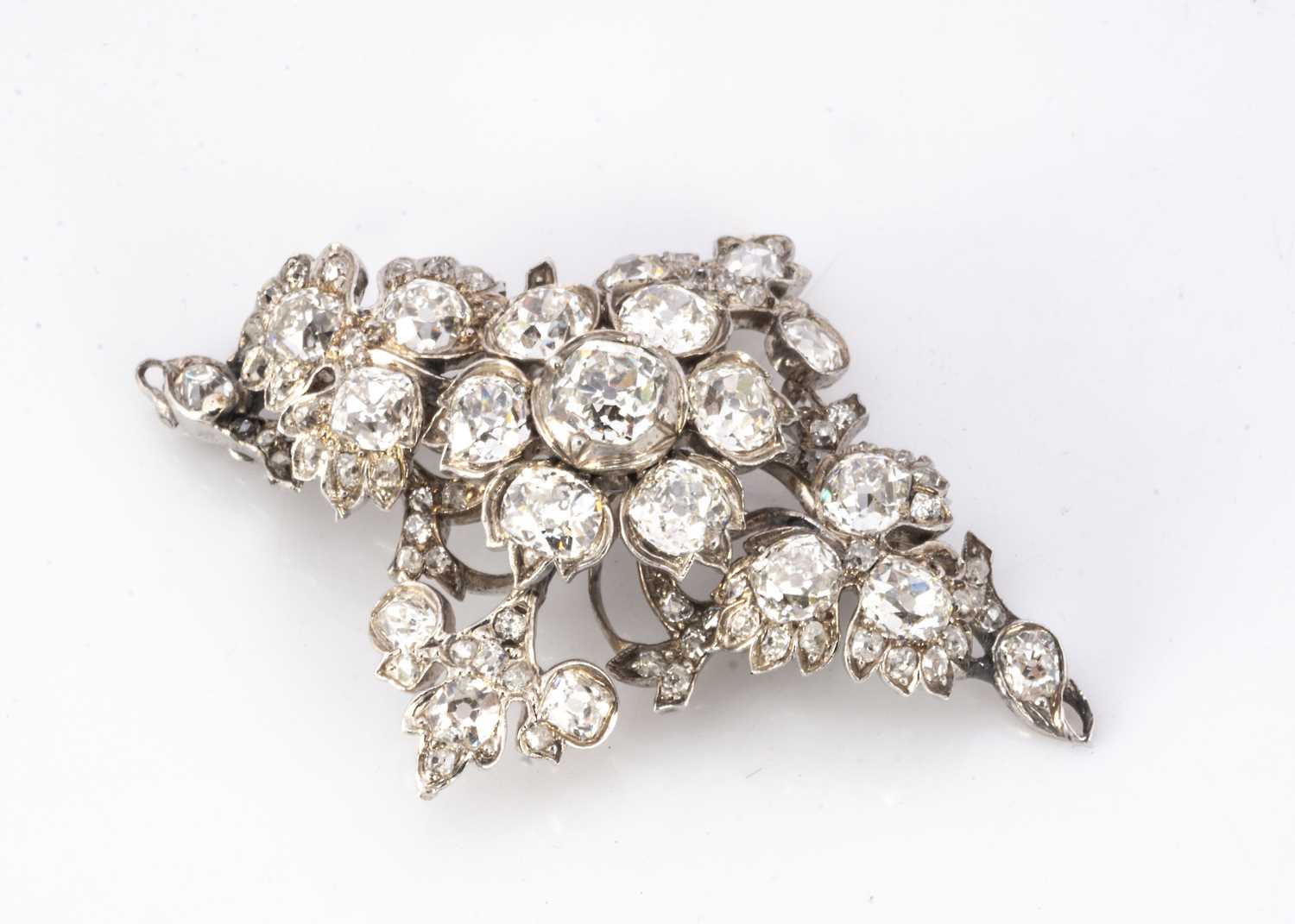 A late 19th and early 20th century navette shaped diamond cluster brooch,