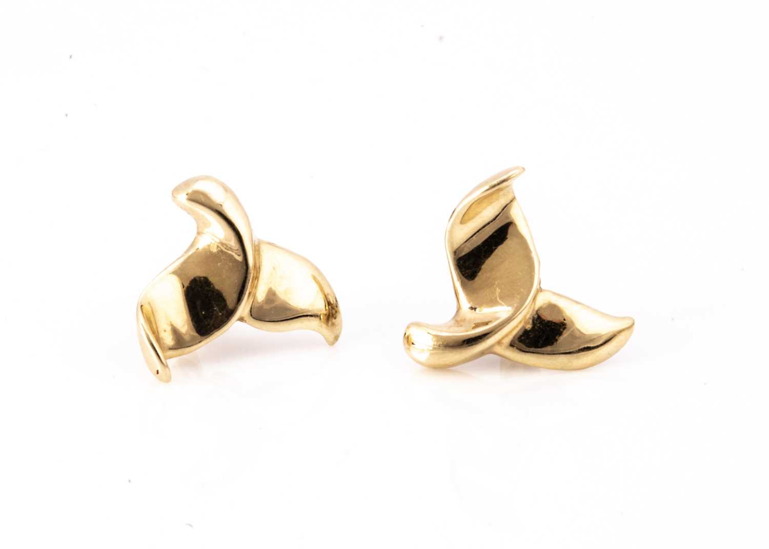 A pair of continental 14k marked whales tail ear studs,