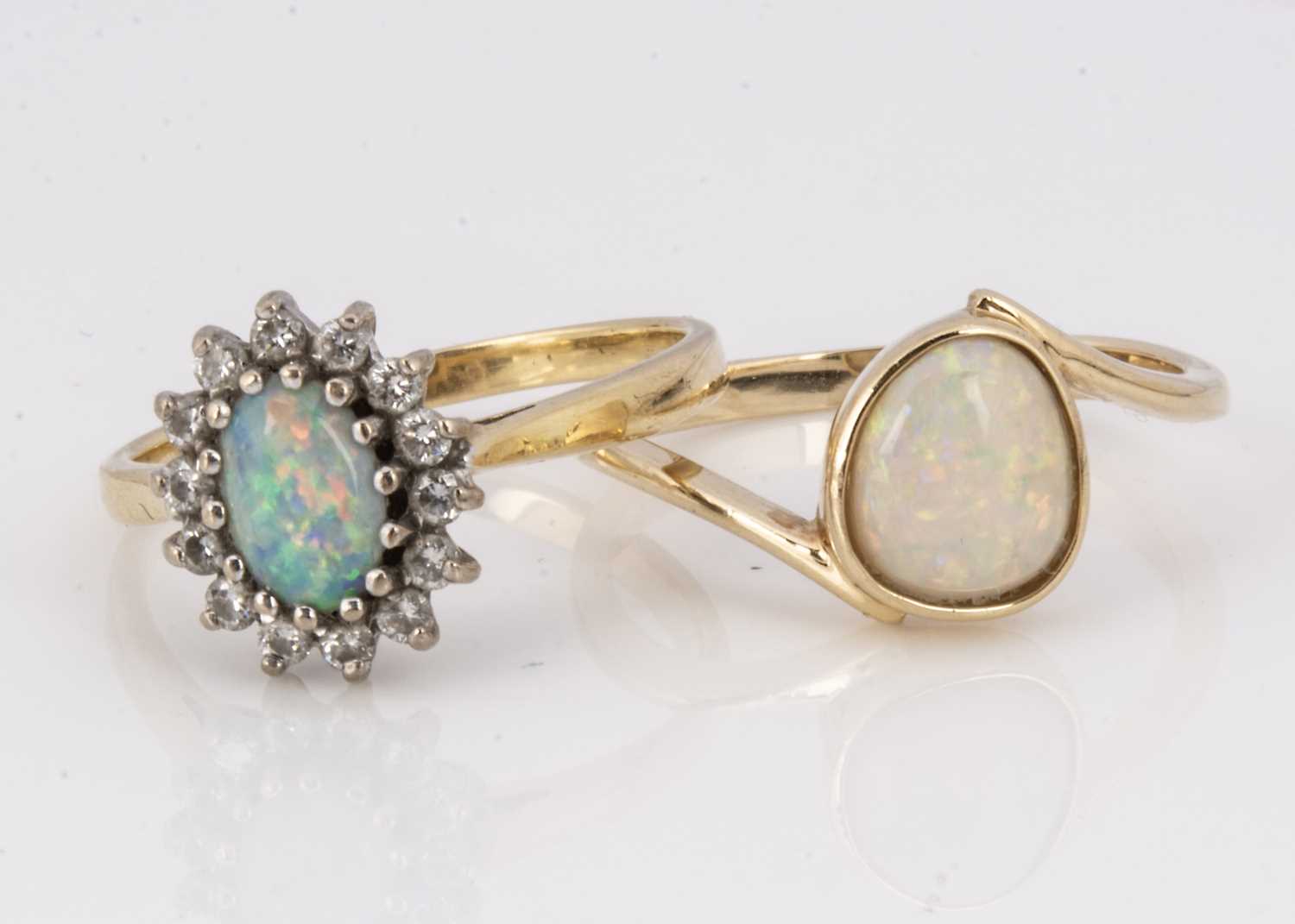 Two opal dress rings,