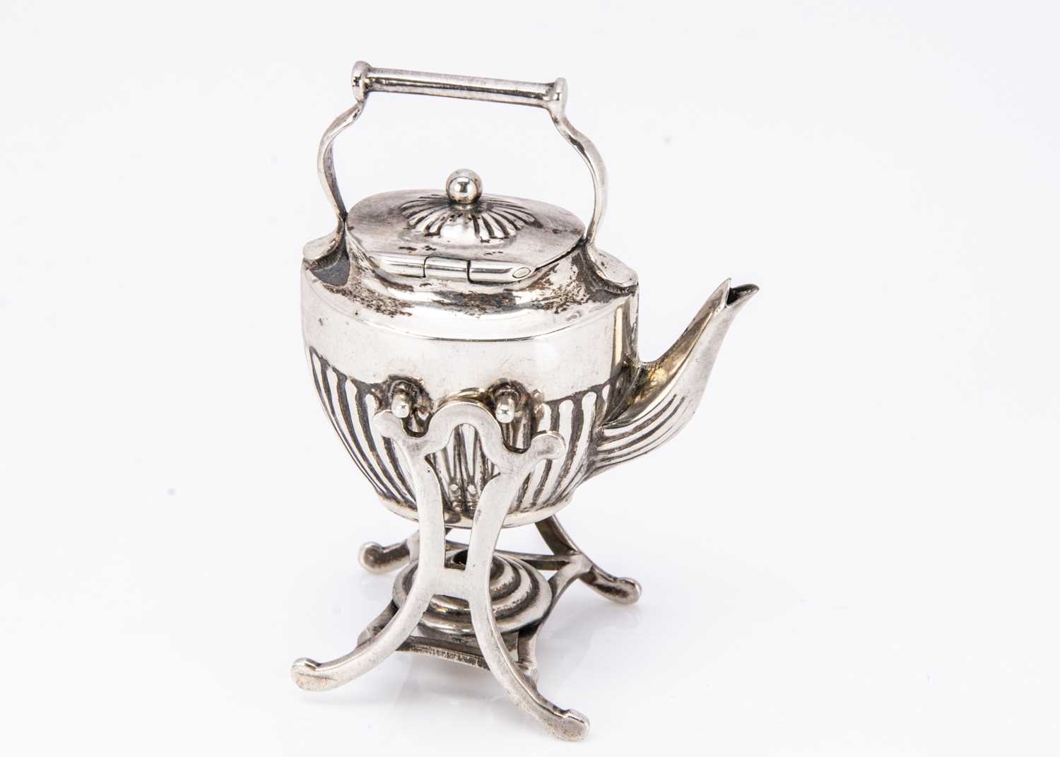 A miniature silver kettle on stand,