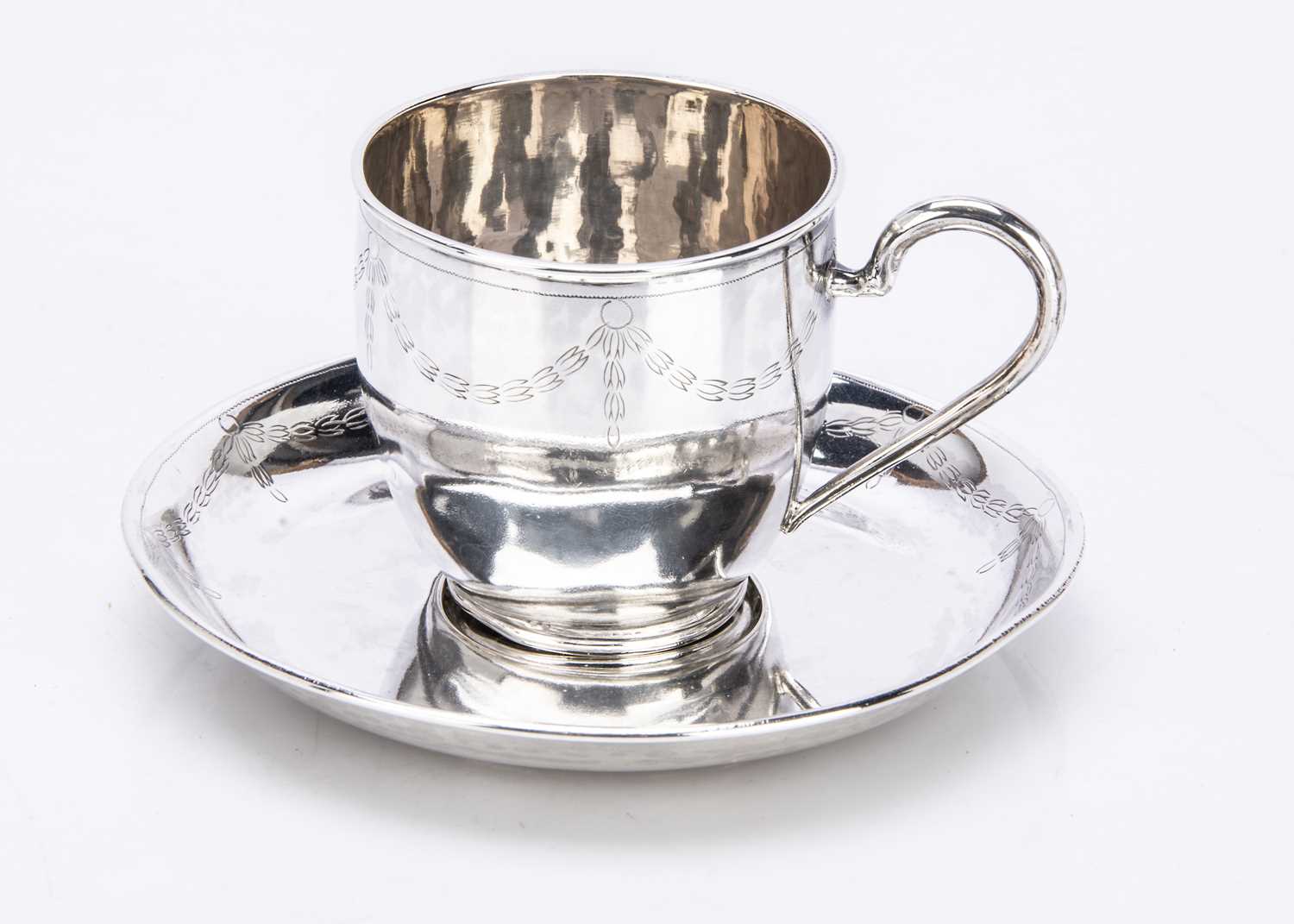 An early 20th Century continental silver teacup and saucer,