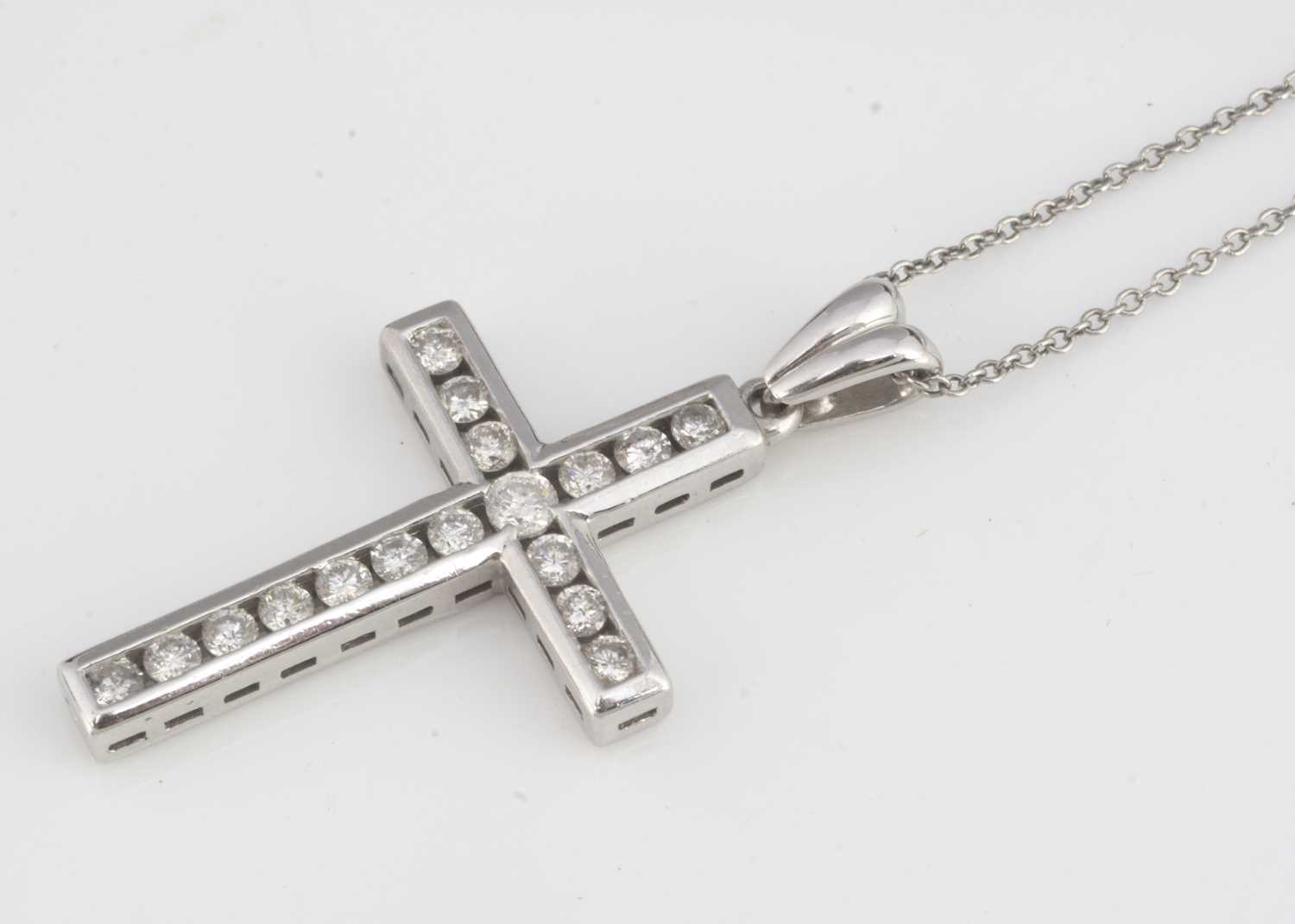 A 9ct gold diamond set cross pendant,