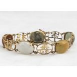 A Chinese 14K marked yellow metal and hardstone bracelet,