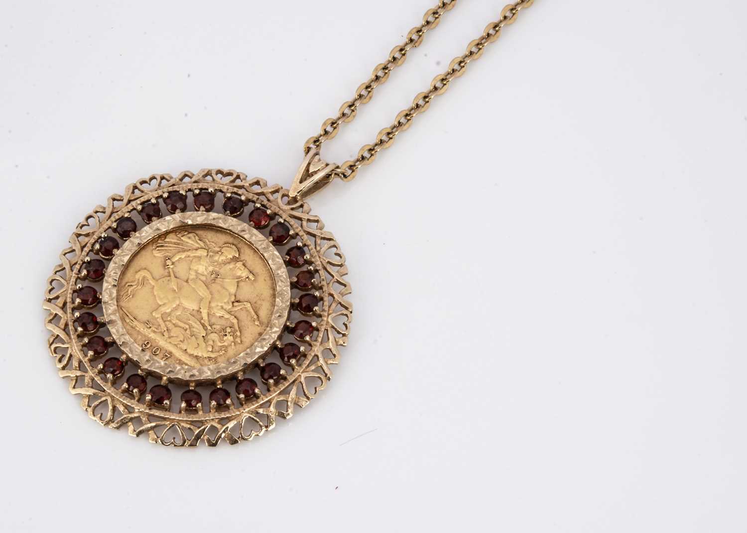 A full Sovereign garnet and gold mounted pendant,
