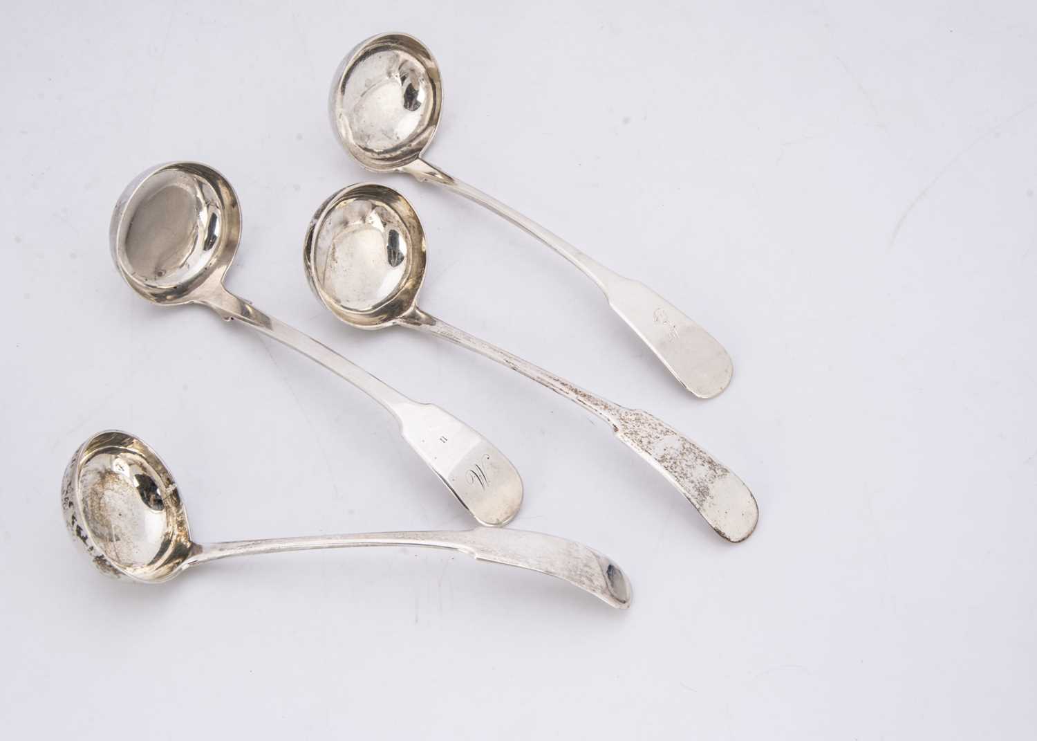 Four Georgian and later silver sauce or toddy ladles,