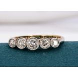 An 18ct gold and platinum five stone diamond dress ring,