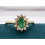 An 18ct gold emerald and diamond cluster ring,