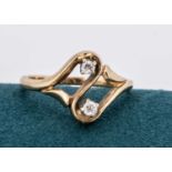 A 14k marked continental diamond cross-over ring,