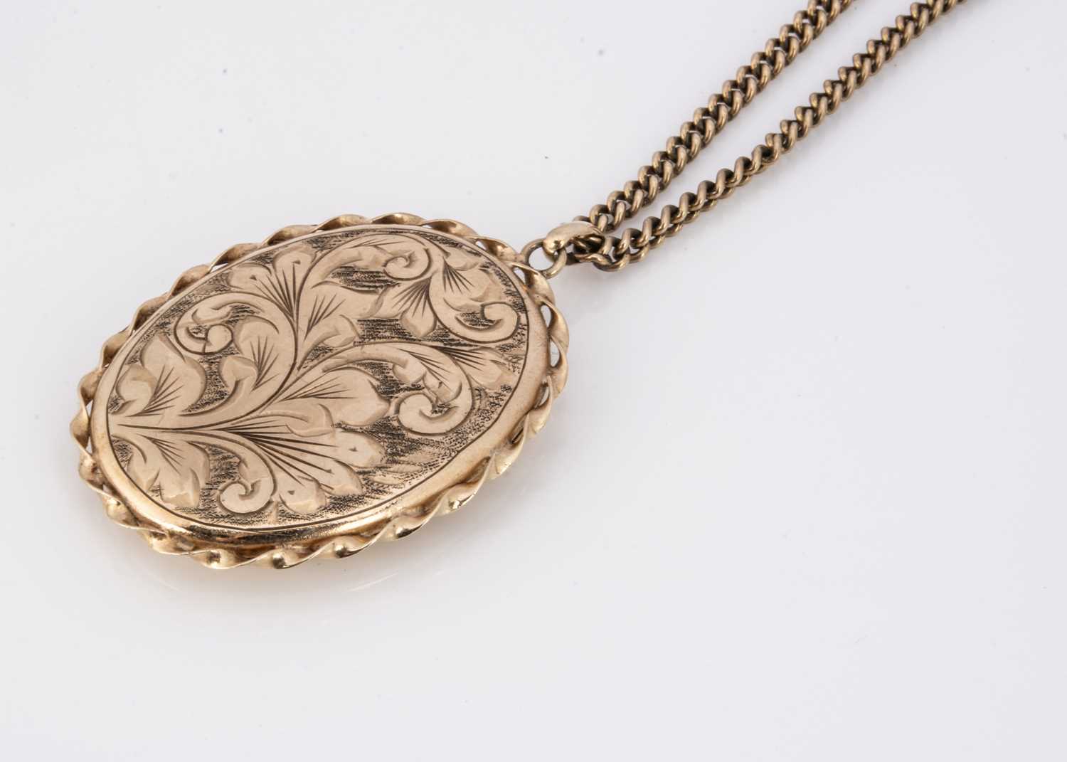 A 9ct gold oval engraved locket,