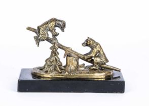 A late 19th century brass desk paperclip of two bears on see-saw,