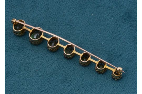 A green zircon graduated bar brooch, - Image 2 of 2