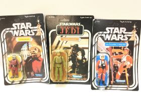 A Box Containing Vintage Star Wars ships. 2 reproduction carded Figures and a Carded Rebel Commando.