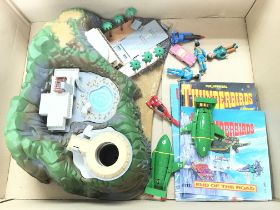 A Box Containing a Thunderbirds Tracey Island with accessories. NO RESERVE